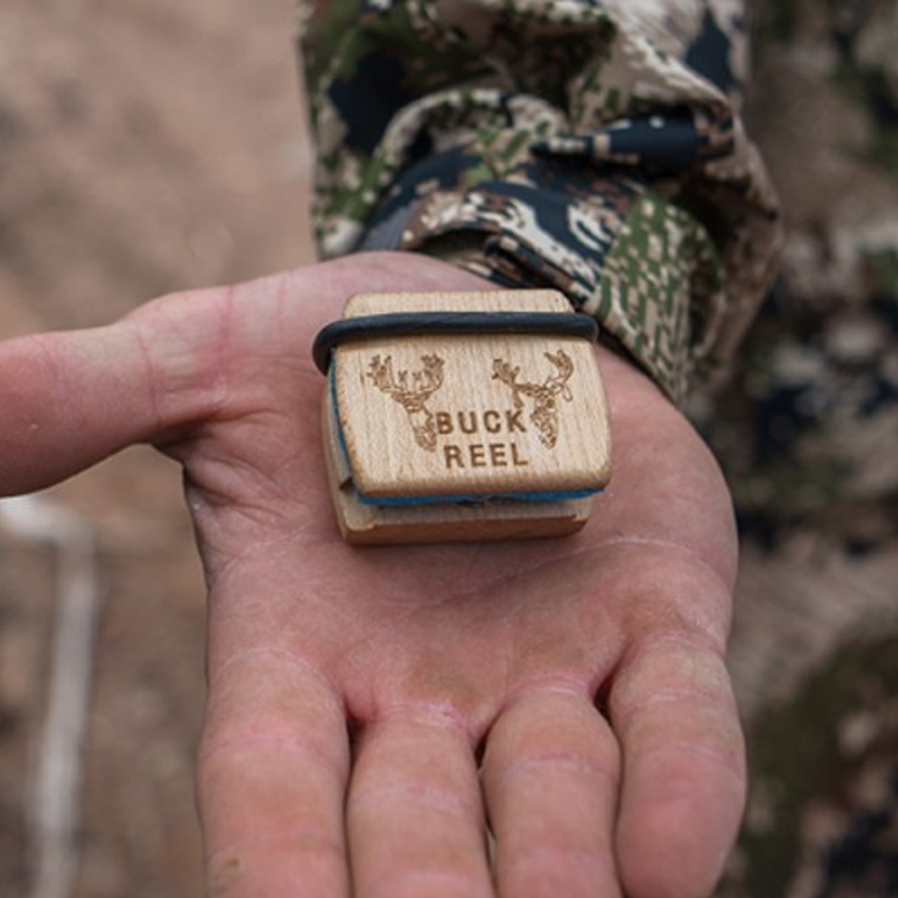 Buck Reel deer call in a hunter's palm
