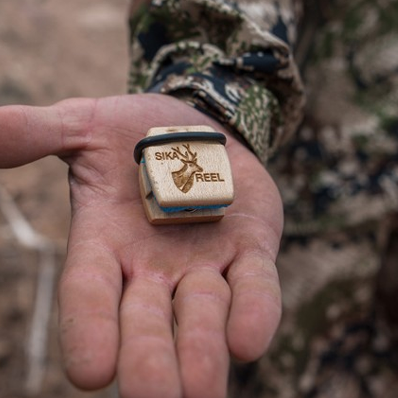 Sika Reel deer call in a hunter's palm
