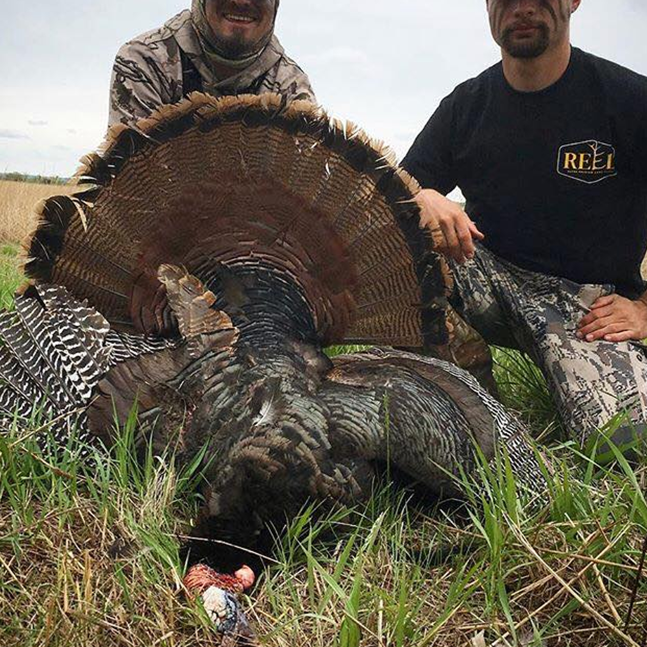 Photo of two hunters with their turkey