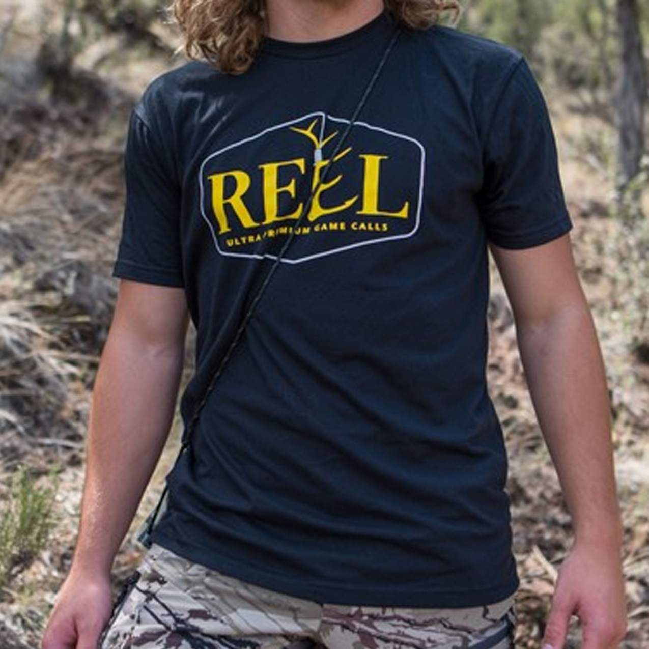 Photo of a man wearing the black Reel Game Calls logo t-shirt