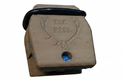 Brown elk call with 'Elk Reel' branding on a wooden surface