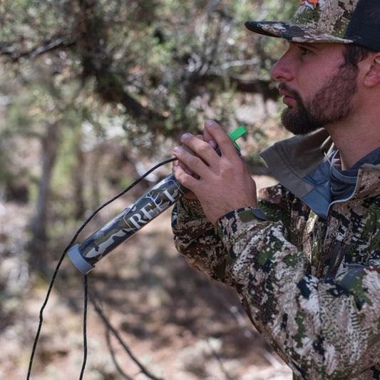 Hunter holding Elk Reel OTC Compact bugle in the woods