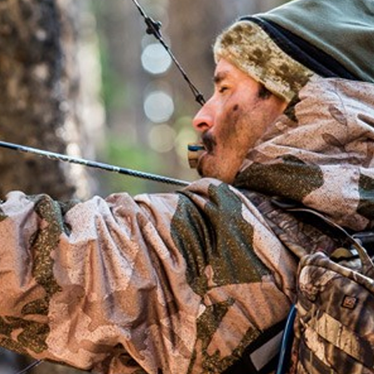 Bow hunter using the Elk Reel classic call hardwood with no hands