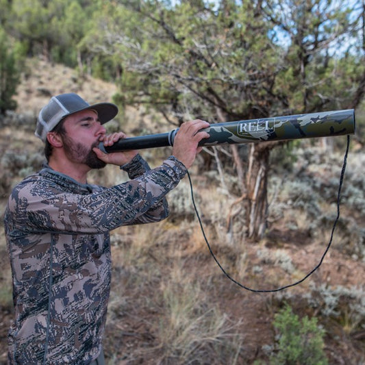 Hunter using the Elk Reel ExtendaBull bugle in the woods