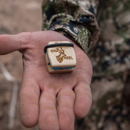 Sika Reel deer call in a hunter's palm